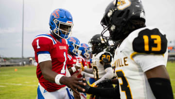 Noxubee County Tigers quarterback Kamario Taylor (1) greets the Starkville high captains before the two teams kicked off the 2024 MHSAA football season on Friday, Aug. 30 in Macon, Miss.