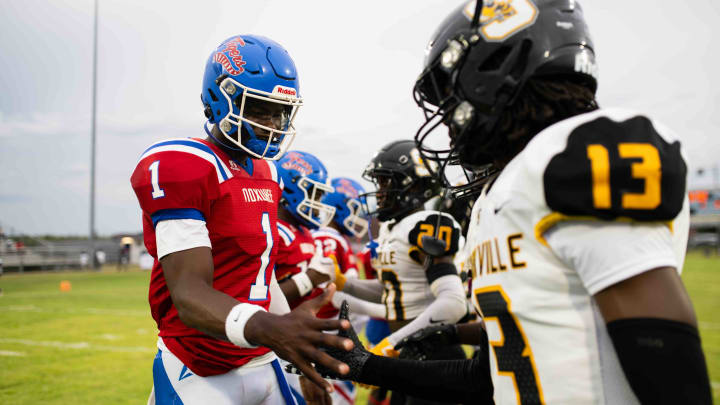 Noxubee County Tigers quarterback Kamario Taylor (1) greets the Starkville high captains before the two teams kicked off the 2024 MHSAA football season on Friday, Aug. 30 in Macon, Miss.