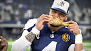 Dallas Cowboys Dak Prescott eats a turkey leg after the Cowboys victory on Thanksgiving