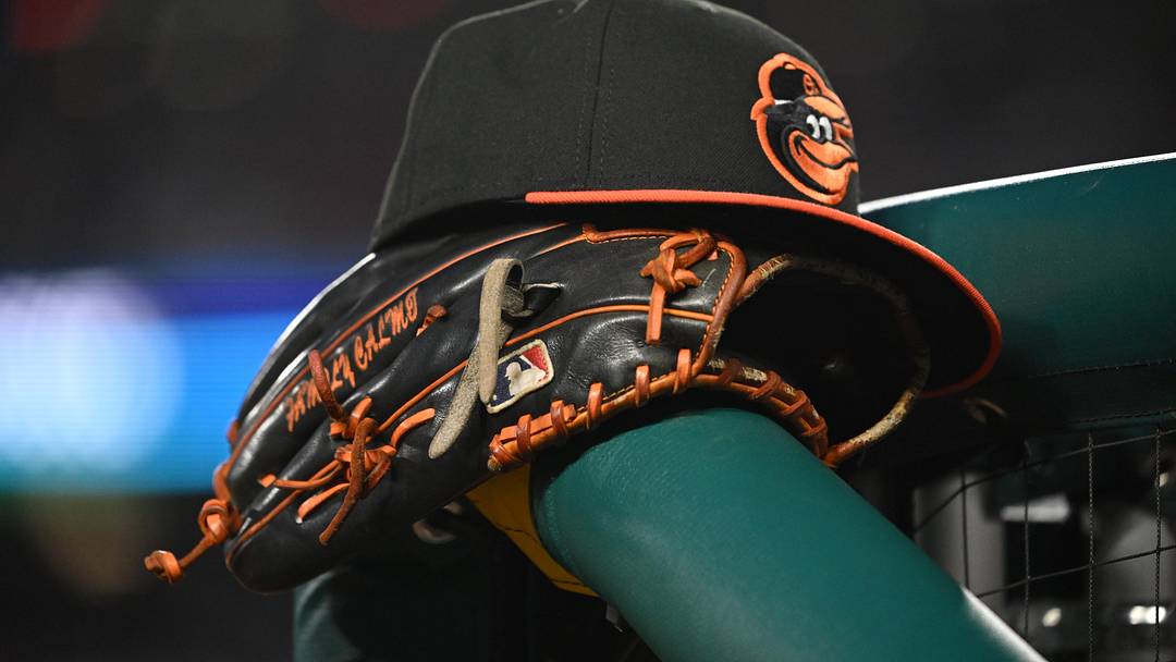 May 8, 2024; Washington, District of Columbia, USA; A Baltimore Orioles hat and glove rest on the dugout rail during a game against the Washington Nationals at Nationals Park. 