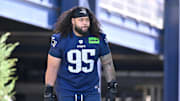 Jul 23, 2025; Foxborough, MA, USA; New England Patriots defensive tackle Khyiris Tonga (95)  walks to the practice field for training camp at Gillette Stadium. Mandatory Credit: Eric Canha-Imagn Images