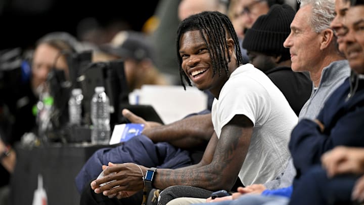 2024 Heisman Trophy winner Travis Hunter Jr. laughs during the second half of the game between the Dallas Mavericks and the Minnesota Timberwolves at the American Airlines Center. 