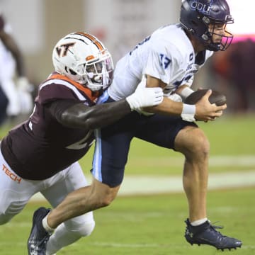 Sep 2, 2023; Blacksburg, Virginia, USA; Old Dominion Monarchs quarterback Grant Wilson (13) gets tackled by Virginia Tech Hokies defensive lineman Mario Kendricks (22)  in the third quarter at Lane Stadium.