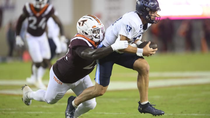 Sep 2, 2023; Blacksburg, Virginia, USA; Old Dominion Monarchs quarterback Grant Wilson (13) gets tackled by Virginia Tech Hokies defensive lineman Mario Kendricks (22)  in the third quarter at Lane Stadium.