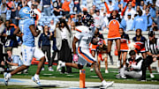 Oct 25, 2025; Chapel Hill, North Carolina, USA; Virginia Cavaliers wide receiver Trell Harris (11) breaks a tackle and scores a touchdown as North Carolina Tar Heels linebacker Khmori House (7) defends in the second quarer at Kenan Stadium. Mandatory Credit: Bob Donnan-Imagn Images