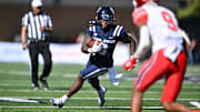 Sep 14, 2024; Logan, Utah, USA;  Utah State Aggies running back Rahsul Faison (3) looks for running room in the first half against the Utah Utes at Merlin Olsen Field at Maverik Stadium. Mandatory Credit: Jamie Sabau-Imagn Images