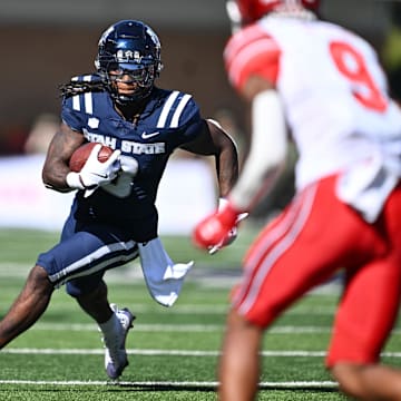 Sep 14, 2024; Logan, Utah, USA;  Utah State Aggies running back Rahsul Faison (3) looks for running room in the first half against the Utah Utes at Merlin Olsen Field at Maverik Stadium. Mandatory Credit: Jamie Sabau-Imagn Images