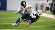 Jan 5, 2025; Indianapolis, Indiana, USA; Jacksonville Jaguars tight end Luke Farrell (89) is tackled by Indianapolis Colts linebacker Jaylon Carlies (57) during the first quarter at Lucas Oil Stadium. 
