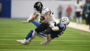 Jan 5, 2025; Indianapolis, Indiana, USA; Jacksonville Jaguars tight end Luke Farrell (89) is tackled by Indianapolis Colts linebacker Jaylon Carlies (57) during the first quarter at Lucas Oil Stadium. 