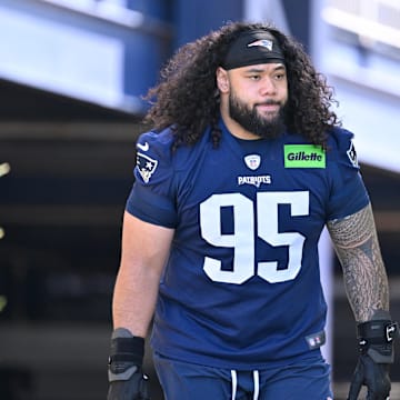 Jul 23, 2025; Foxborough, MA, USA; New England Patriots defensive tackle Khyiris Tonga (95)  walks to the practice field for training camp at Gillette Stadium. Mandatory Credit: Eric Canha-Imagn Images