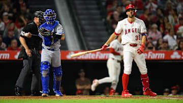 Sep 25, 2025; Anaheim, California, USA; Los Angeles Angels left fielder Chris Taylor (33), right, reacts after striking out during the sixth inning against the Kansas City Royals at Angel Stadium. Mandatory Credit: William Liang-Imagn Images