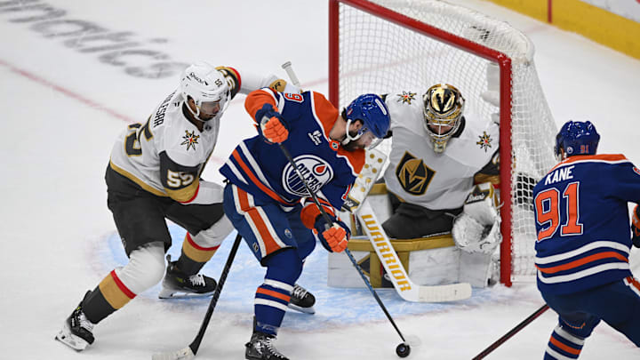 May 12, 2025; Edmonton, Alberta, CAN; Vegas Golden Knights right winger Shea Theodore (55) battles with Edmonton Oilers center Adam Henrique (19) and left winger Evander Kane (91) during the first period in game three of the second round of the 2025 Stanley Cup Playoffs at Rogers Place. Mandatory Credit: Walter Tychnowicz-Imagn Images
