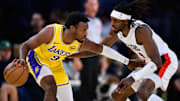 Oct 27, 2025; Los Angeles, California, USA; Los Angeles Lakers guard Bronny James (9) controls the ball under pressure from Portland Trail Blazers forward Jerami Grant (9) during the first half at Crypto.com Arena. Mandatory Credit: William Liang-Imagn Images
