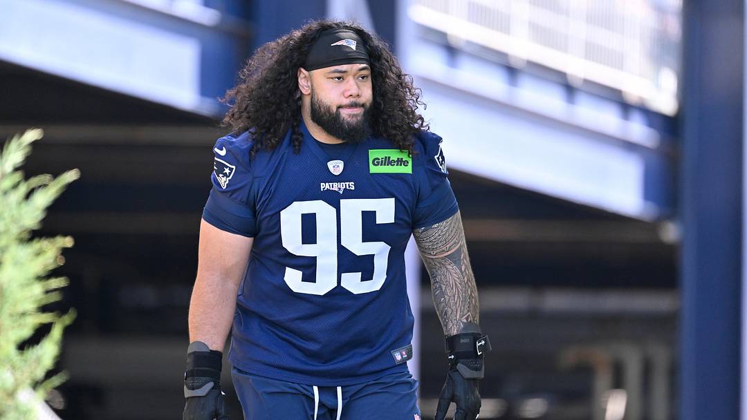 Jul 23, 2025; Foxborough, MA, USA; New England Patriots defensive tackle Khyiris Tonga (95)  walks to the practice field for training camp at Gillette Stadium. Mandatory Credit: Eric Canha-Imagn Images