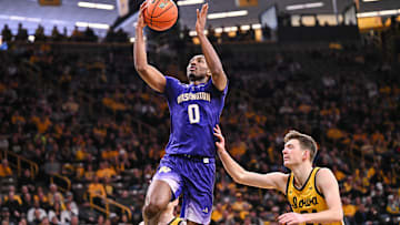 Feb 22, 2025; Iowa City, Iowa, USA; Washington Huskies guard Mekhi Mason (0) goes to the basket as Iowa Hawkeyes forward Pryce Sandfort (24) defends during the first half at Carver-Hawkeye Arena. Mandatory Credit: Jeffrey Becker-Imagn Images
