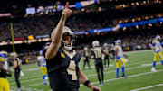Dec 1, 2024; New Orleans, Louisiana, USA; New Orleans Saints quarterback Derek Carr (4) reacts after rushing for a first down against the Los Angeles Rams during the fourth quarter at Caesars Superdome. Mandatory Credit: Matthew Hinton-Imagn Images