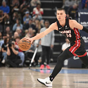 Mar 15, 2025; Memphis, Tennessee, USA; Miami Heat point guard Tyler Herro (14) reaches for the loose ball in the second quarter of the game against the Memphis Grizzlies at FedExForum. Mandatory Credit: Matthew Smith-Imagn Images