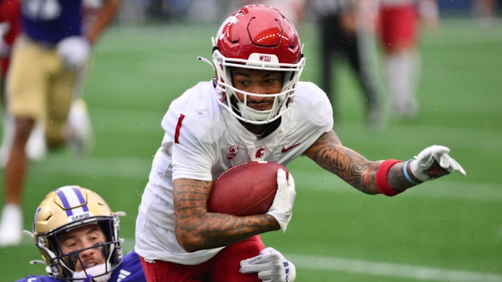 Sep 14, 2024; Seattle, Washington, USA; Washington State Cougars wide receiver Kris Hutson (1) carries the ball after making a catch against the Washington Huskies during the second half at Lumen Field. Mandatory Credit: Steven Bisig-Imagn Images