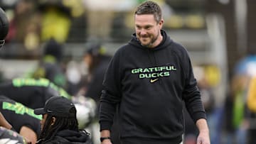Oct 25, 2025; Eugene, Oregon, USA; Oregon Ducks head coach Dan Lanning encourages players during warm ups before a game against the Wisconsin Badgers at Autzen Stadium. The Ducks are wearing uniforms celebrating the Grateful Dead. Mandatory Credit: Troy Wayrynen-Imagn Images
