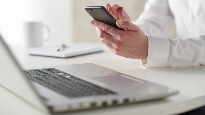 Businessman Using Smartphone And Laptop Businessman Using Smartphone And Laptop
