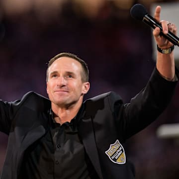 Oct 17, 2024; New Orleans, Louisiana, USA; New Orleans Saints retired quarterback Drew Brees (9) reacts during his hall of fame ceremony at halftime against the Denver Broncos at Caesars Superdome. Mandatory Credit: Matthew Hinton-Imagn Images