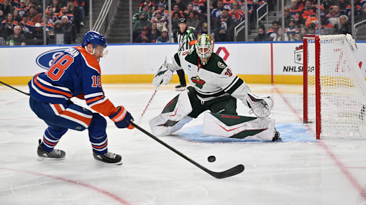 Dec 2, 2025; Edmonton, Alberta, CAN; Edmonton Oilers left wing Zach Hyman (18) goes for the puck in front of Minnesota Wild goalie Jesper Wallstedt (30) during the third period at Rogers Place. Mandatory Credit: Walter Tychnowicz-Imagn Images
