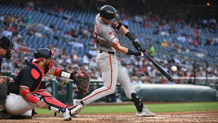 Aug 5, 2024; Washington, District of Columbia, USA; San Francisco Giants center fielder Tyler Fitzgerald (49) hits the ball into play against the Washington Nationals during the fifth inning at Nationals Park.