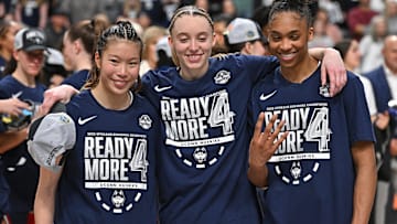 UConn Huskies guard Kaitlyn Chen (20), guard Paige Bueckers (5) and forward Aubrey Griffin (44) pose for a photo after a Elite 8 NCAA Tournament basketball game against the USC Trojans at Spokane Arena. 