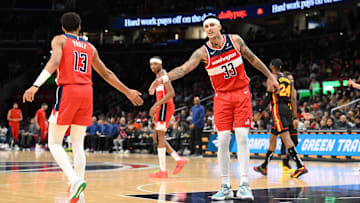 Dec 31, 2023; Washington, District of Columbia, USA;  Washington Wizards forward Kyle Kuzma (33) celebrates with guard Jordan Poole (13) during the first half against the Atlanta Hawks at Capital One Arena. Mandatory Credit: James A. Pittman-Imagn Images