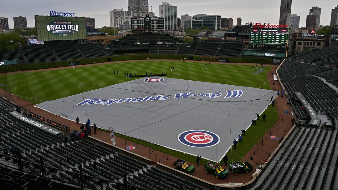 May 3, 2026; Chicago, Illinois, USA; A general wide view of the rain tarp over the field prior to a game between the Chicago Cubs and the Arizona Diamondbacks at Wrigley Field. Mandatory Credit: Patrick Gorski-Imagn Images May 3, 2026; Chicago, Illinois, USA; A general wide view of the rain tarp over the field prior to a game between the Chicago Cubs and the Arizona Diamondbacks at Wrigley Field. Mandatory Credit: Patrick Gorski-Imagn Images