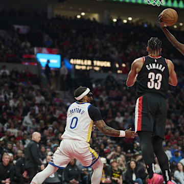 Apr 11, 2025; Portland, Oregon, USA; Portland Trail Blazers center Duop Reath (26) grabs a rebound during the first half against Golden State Warriors guard Gary Payton II (0) at Moda Center. Mandatory Credit: Troy Wayrynen-Imagn Images