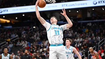 Oct 26, 2025; Washington, District of Columbia, USA; Charlotte Hornets center Ryan Kalkbrenner (11) grabs a rebound against the Washington Wizards during the first quarter at Capital One Arena. Mandatory Credit: Rafael Suanes-Imagn Images