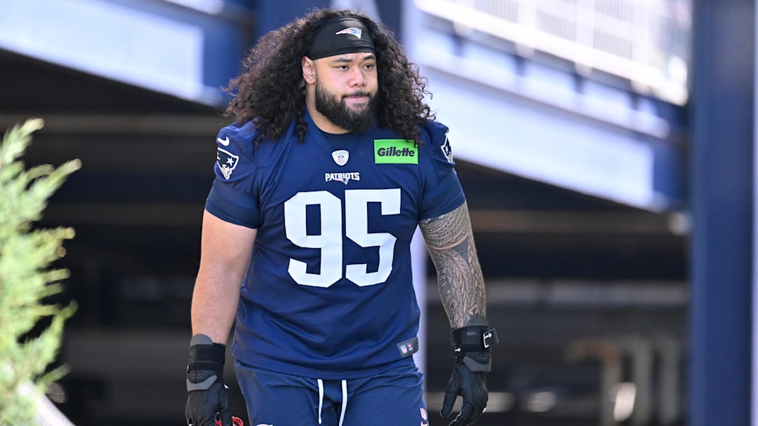 New England Patriots defensive tackle Khyiris Tonga (95)  walks to the practice field for training camp at Gillette Stadium.