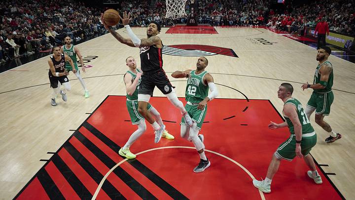 Mar 23, 2025; Portland, Oregon, USA: Portland Trail Blazers guard Anfernee Simons (1) scores a basket during the second half against Boston Celtics center Al Horford (42) and forward Sam Hauser (30) at Moda Center. Mandatory Credit: Troy Wayrynen-Imagn Images