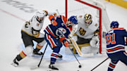 May 12, 2025; Edmonton, Alberta, CAN; Vegas Golden Knights right winger Shea Theodore (55) battles with Edmonton Oilers center Adam Henrique (19) and left winger Evander Kane (91) during the first period in game three of the second round of the 2025 Stanley Cup Playoffs at Rogers Place. Mandatory Credit: Walter Tychnowicz-Imagn Images