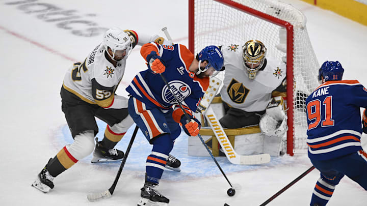 May 12, 2025; Edmonton, Alberta, CAN; Vegas Golden Knights right winger Shea Theodore (55) battles with Edmonton Oilers center Adam Henrique (19) and left winger Evander Kane (91) during the first period in game three of the second round of the 2025 Stanley Cup Playoffs at Rogers Place. Mandatory Credit: Walter Tychnowicz-Imagn Images