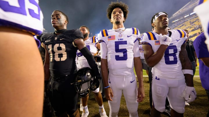 Oct 21, 2023; Baton Rouge, Louisiana, USA; Army Black Knights linebacker Elo Modozie (18), LSU Tigers quarterback Jayden Daniels (5), and wide receiver Malik Nabers (8) stand for the Army alma mater after LSU defeated Army at Tiger Stadium.  