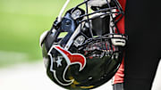 Sep 22, 2024; Minneapolis, Minnesota, USA; A Houston Texans player holds onto his helmet from the sideline during the game against the Minnesota Vikings at U.S. Bank Stadium. Mandatory Credit: Jeffrey Becker-Imagn Images