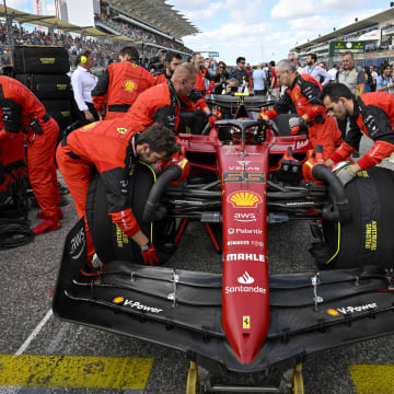 Oct 23, 2022; Austin, Texas, USA; The crew of Scuderia Ferrari driver Carlos Sainz (55) of Team Spain wheel their car onto the grid before the start of the U.S. Grand Prix F1 race at Circuit of the Americas. Mandatory Credit: Jerome Miron-USA TODAY Sports