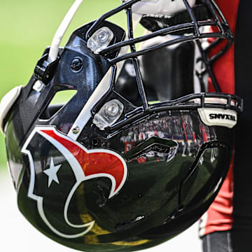 Sep 22, 2024; Minneapolis, Minnesota, USA; A Houston Texans player holds onto his helmet from the sideline during the game against the Minnesota Vikings at U.S. Bank Stadium. Mandatory Credit: Jeffrey Becker-Imagn Images