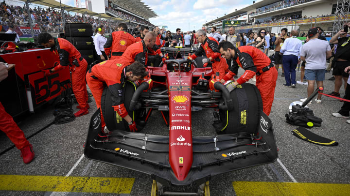 Oct 23, 2022; Austin, Texas, USA; The crew of Scuderia Ferrari driver Carlos Sainz (55) of Team Spain wheel their car onto the grid before the start of the U.S. Grand Prix F1 race at Circuit of the Americas. Mandatory Credit: Jerome Miron-USA TODAY Sports