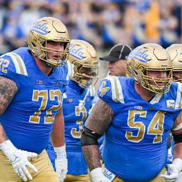 Nov 30, 2024; Pasadena, California, USA; UCLA Bruins offensive linemen Garrett DiGiorgio (72) and Josh Carlin (54) during the second quarter against the Fresno State Bulldogs at Rose Bowl. Mandatory Credit: Robert Hanashiro-Imagn Images