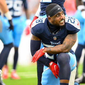 Tennessee Titans safety Quandre Diggs slams his helmet down after an ankle injury against the New England Patriots.