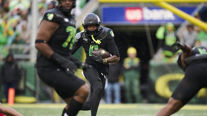 Oct 25, 2025; Eugene, Oregon, USA; Oregon Ducks wide receiver Malik Benson (4) carries the ball during the first half against the Wisconsin Badgers at Autzen Stadium. Mandatory Credit: Troy Wayrynen-Imagn Images