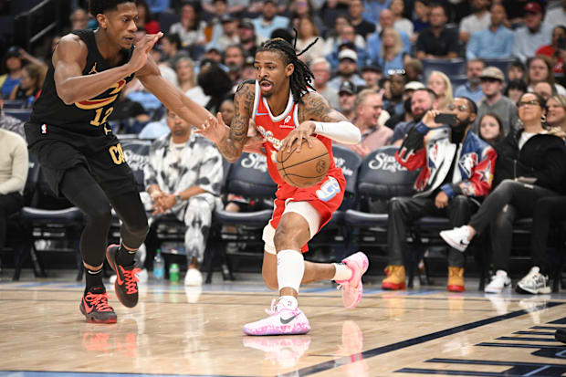 Memphis Grizzlies point guard Ja Morant (12) pump fakes his defender Cleveland Cavaliers small forward De'Andre Hunter (12)