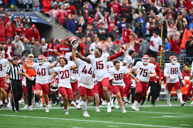 The Cougars celebrate defeating the Huskies in the Apple Cup rivalry game.