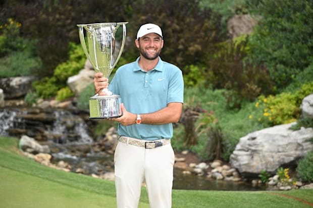 Scottie Scheffler holds a trophy