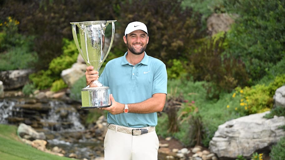 Scottie Scheffler holds a trophy