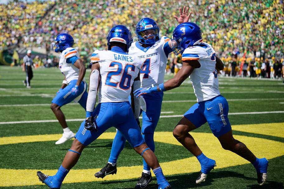 Boise State Broncos running back Sire Gaines celebrates with quarterback Maddux Madsen and wide receiver Cam Bates.