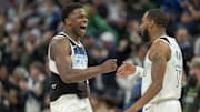 Minnesota Timberwolves guard Anthony Edwards celebrates with teammate Mike Conley.